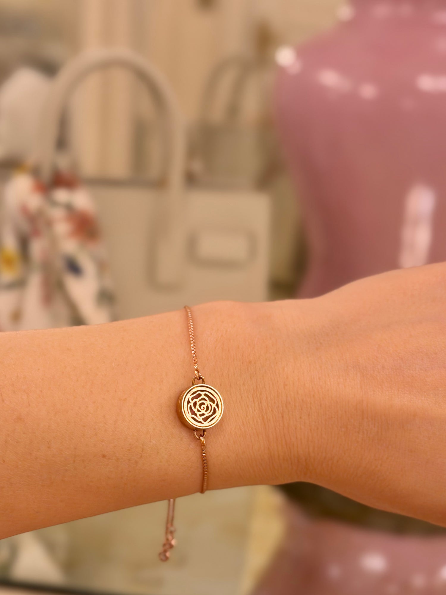 Rose gold aromatherapy bracelet with rose design on a wrist